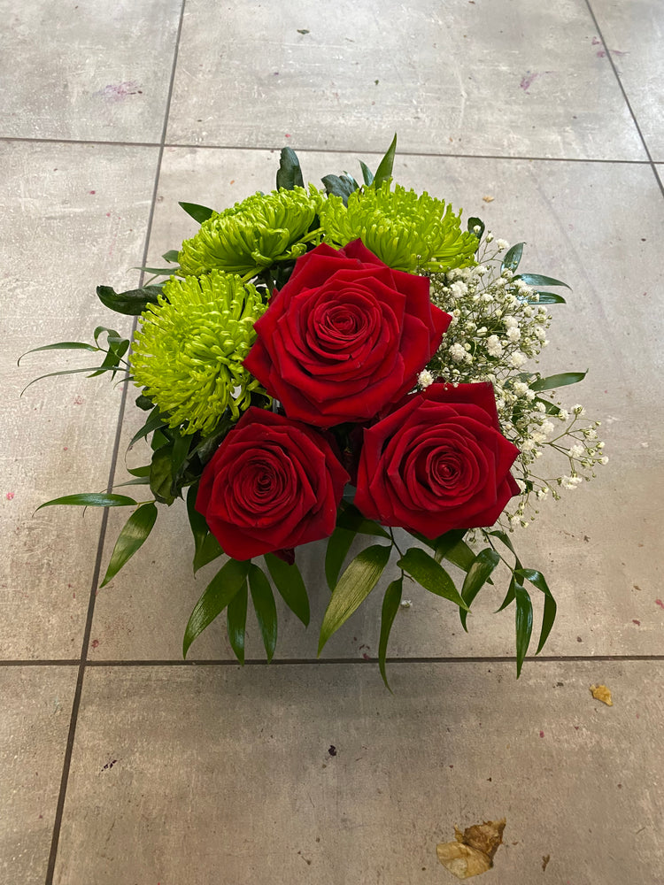 Shamrock and roses arrangement in a vase