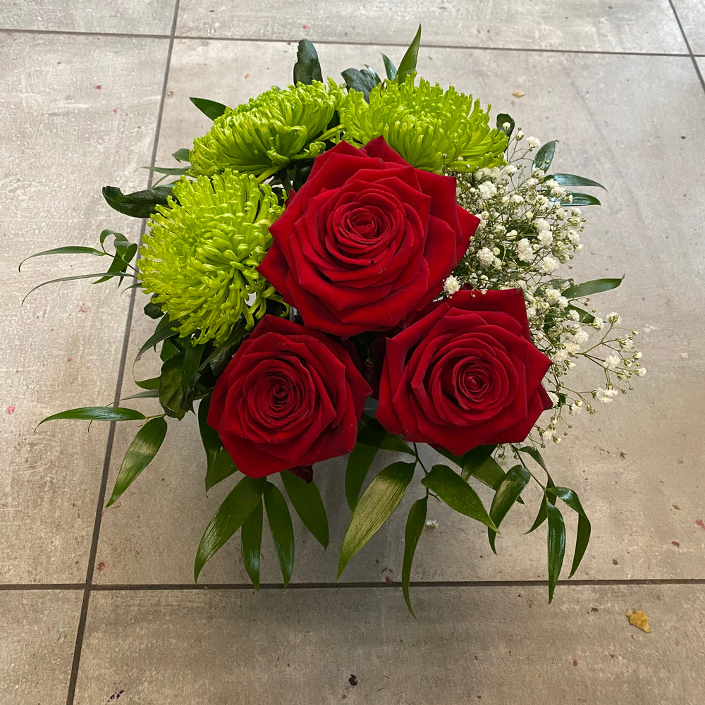 Shamrock and roses arrangement in a vase