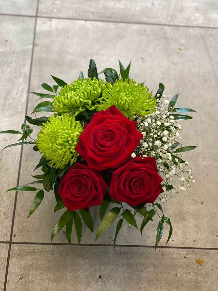 Shamrock and roses arrangement in a vase